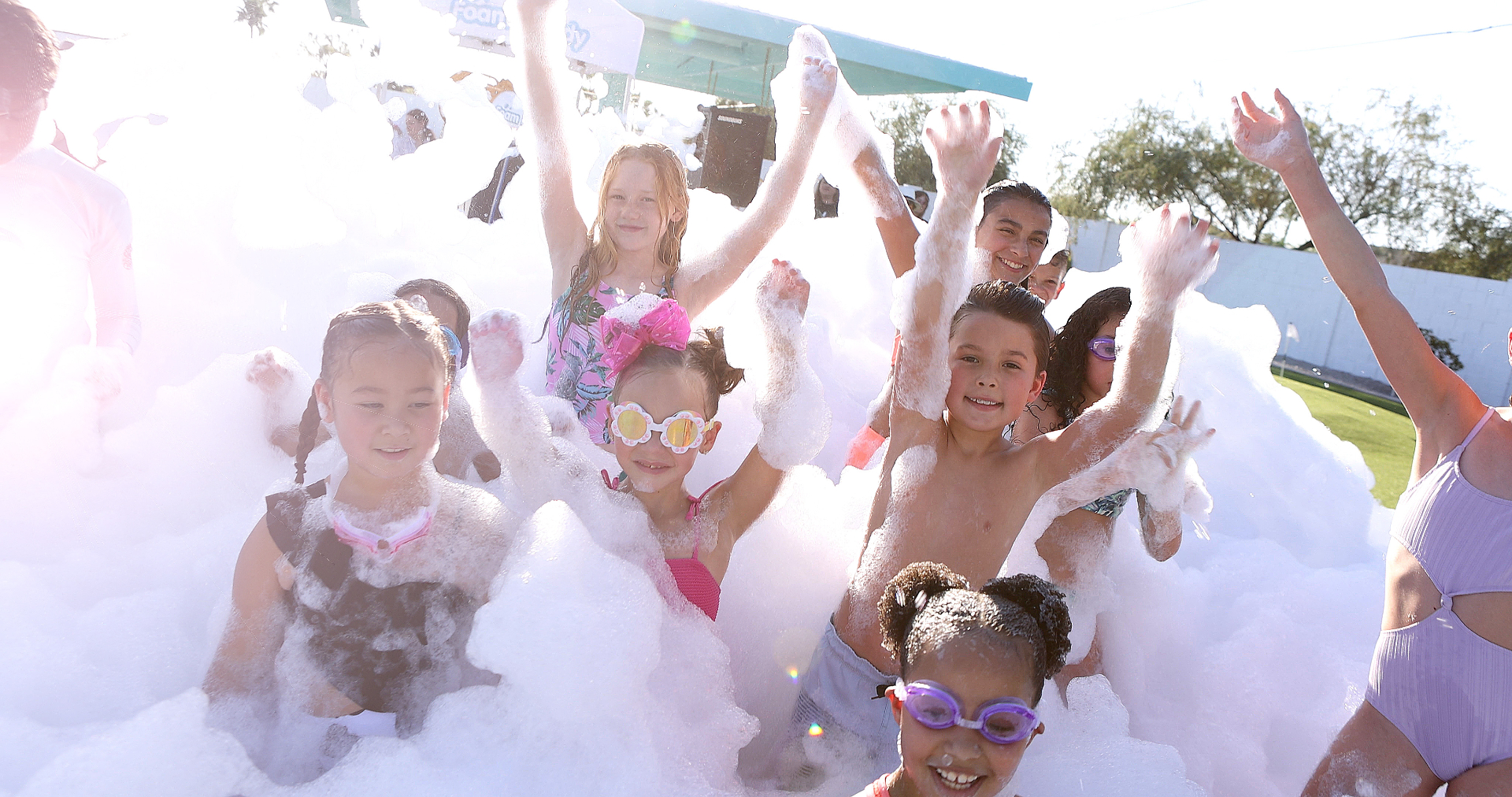 Kids laughing and covered in foam